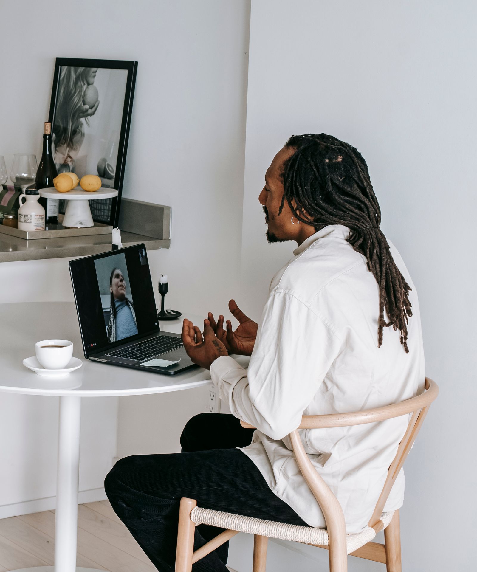 Black patient speaking with a clinician during a video consultation at home